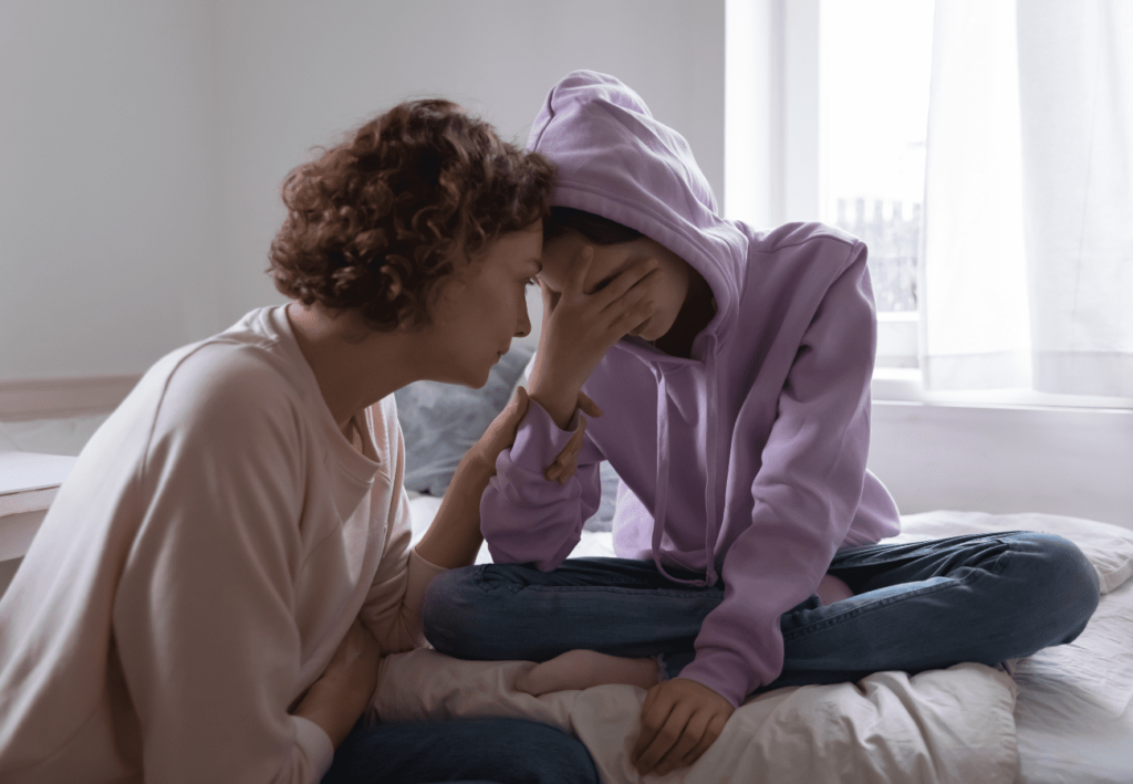 Image of a parent comforting a depressed teenager on Chrysalis Psychiatry's website